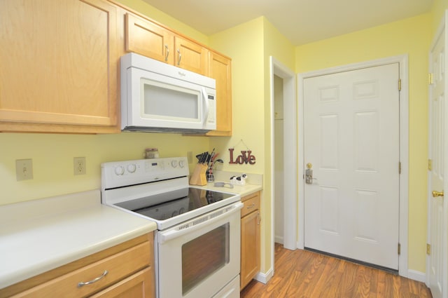 15295 Parkers Grove Rd, Morning View, KY 41063 - kitchen with white appliances, wood finished floors, light brown cabinetry, light countertops, and baseboards