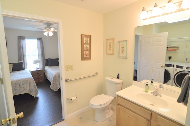 15295 Parkers Grove Rd, Morning View, KY 41063 - ensuite bathroom featuring washing machine and clothes dryer, vanity, toilet, a ceiling fan, and baseboards