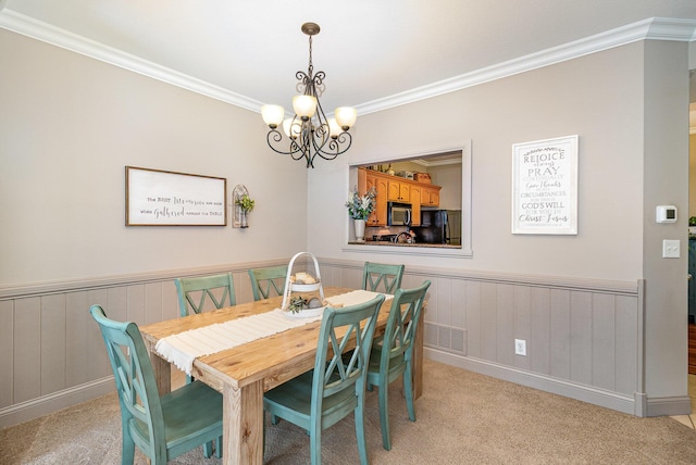 315 Shadow Ridge Dr, Highland Heights, KY 41076 - dining area featuring a chandelier, light carpet, ornamental molding, and wainscoting