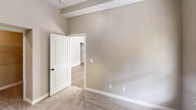 489 Eagle Creek Dr, Dry Ridge, KY 41035 - unfurnished bedroom featuring a walk in closet, baseboards, carpet, and a closet