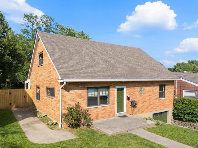 420 Locust St, Erlanger, KY 41018 - view of front facade featuring a shingled roof, brick siding, a front lawn, a gate, and a patio area