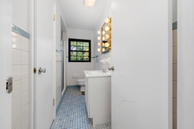 420 Locust St, Erlanger, KY 41018 - bathroom with tile walls, tile patterned flooring, vanity, toilet, and an enclosed shower