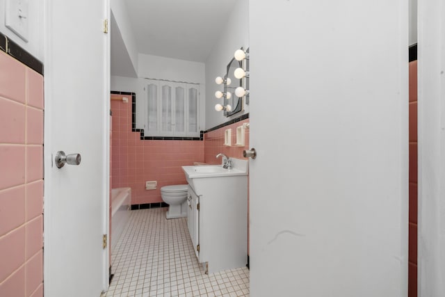 420 Locust St, Erlanger, KY 41018 - full bathroom featuring tile walls, vanity, tile patterned floors, a bath, and toilet