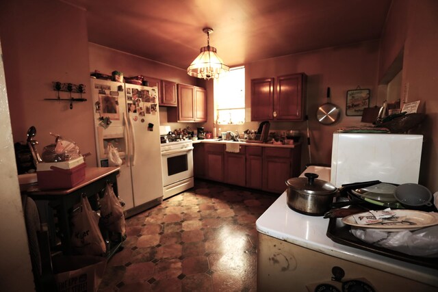 944 Philadelphia St, Covington, KY 41011 - kitchen with white appliances, dark floors, light countertops, pendant lighting, and a sink