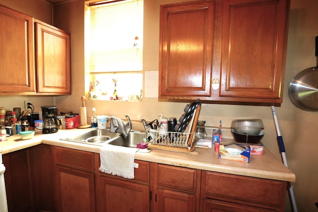 944 Philadelphia St, Covington, KY 41011 - kitchen with light countertops, a sink, and brown cabinetry