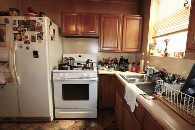 944 Philadelphia St, Covington, KY 41011 - kitchen with white appliances, light countertops, and brown cabinets