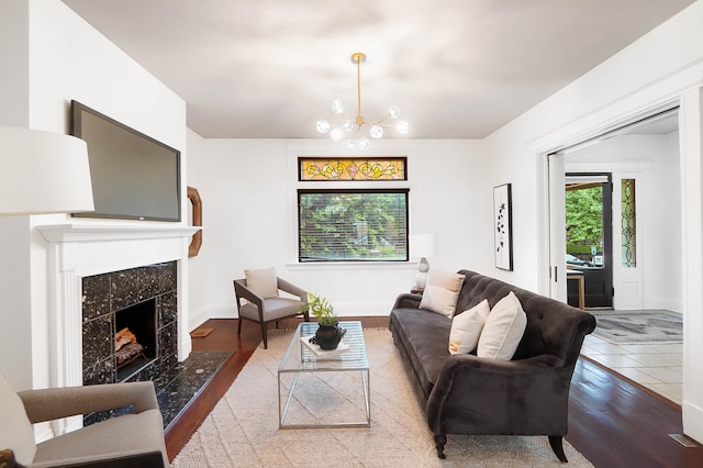 645 Maple Ave, Newport, KY 41071 - living room with a high end fireplace, a chandelier, wood finished floors, and baseboards