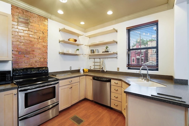 645 Maple Ave, Newport, KY 41071 - kitchen featuring stainless steel appliances, a sink, dark countertops, crown molding, and dark wood-style flooring