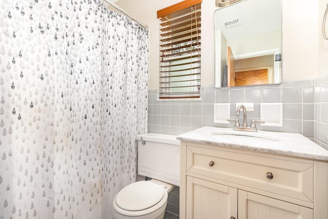 304 Humes Ridge Rd, Williamstown, KY 41097 - bathroom with toilet, vanity, tile walls, a shower with curtain, and a wainscoted wall