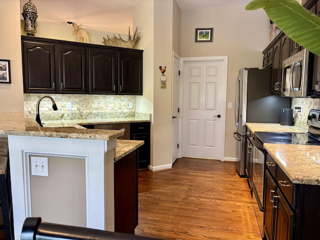 1940 Marktwain Way, Villa Hills, KY 41017 - kitchen featuring black electric range oven, stainless steel microwave, dark wood-type flooring, backsplash, and light stone countertops