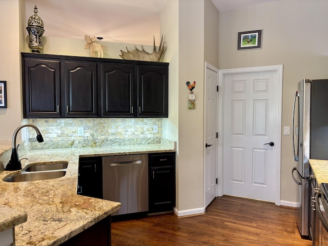 1940 Marktwain Way, Villa Hills, KY 41017 - kitchen featuring appliances with stainless steel finishes, a sink, light stone counters, dark wood-type flooring, and backsplash