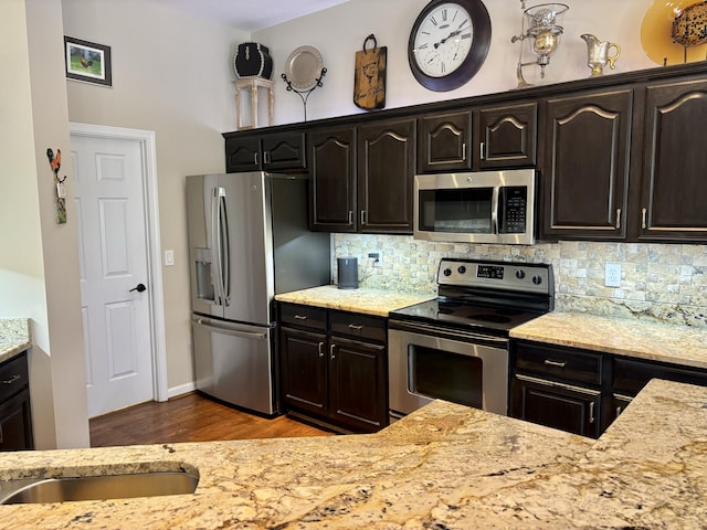 1940 Marktwain Way, Villa Hills, KY 41017 - kitchen featuring stainless steel appliances, decorative backsplash, wood finished floors, and light stone countertops