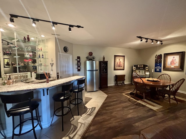 1940 Marktwain Way, Villa Hills, KY 41017 - kitchen with freestanding refrigerator, track lighting, wood finished floors, baseboards, and a breakfast bar area