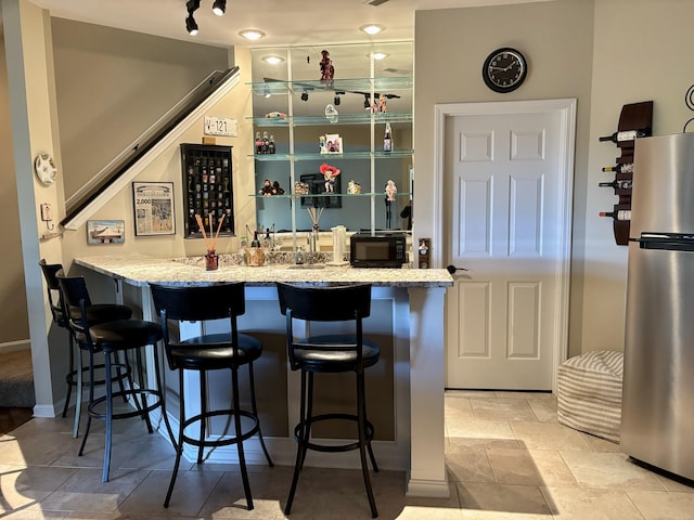 1940 Marktwain Way, Villa Hills, KY 41017 - indoor wet bar with freestanding refrigerator, black microwave, and baseboards