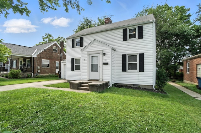 3314 Elizabeth St, Erlanger, KY 41018 - view of front facade featuring a chimney, a front lawn, concrete driveway, and a garage