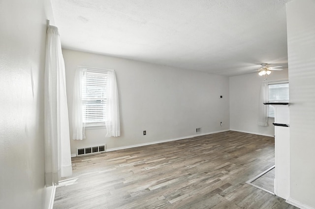 3314 Elizabeth St, Erlanger, KY 41018 - unfurnished living room with healthy amount of natural light, a ceiling fan, and wood finished floors
