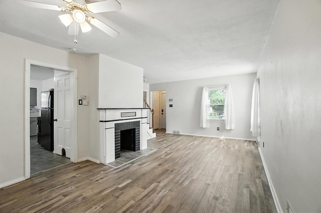 3314 Elizabeth St, Erlanger, KY 41018 - unfurnished living room featuring wood finished floors, a fireplace, and ceiling fan