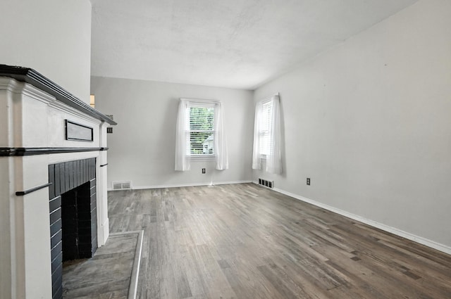3314 Elizabeth St, Erlanger, KY 41018 - unfurnished living room featuring a brick fireplace and wood finished floors