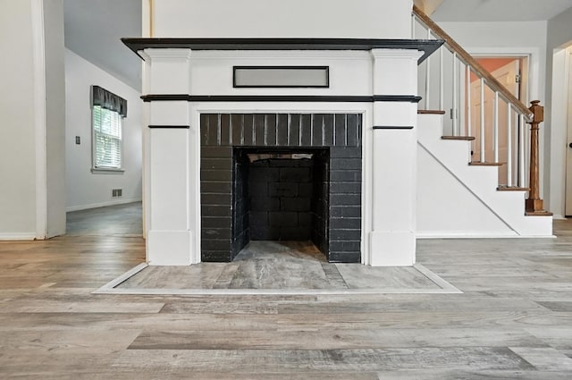 3314 Elizabeth St, Erlanger, KY 41018 - detailed view of wood finished floors and a fireplace with flush hearth