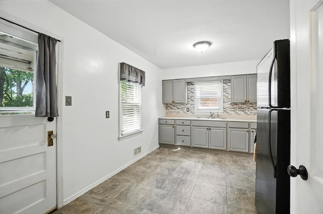3314 Elizabeth St, Erlanger, KY 41018 - kitchen featuring gray cabinets, freestanding refrigerator, tasteful backsplash, and light countertops