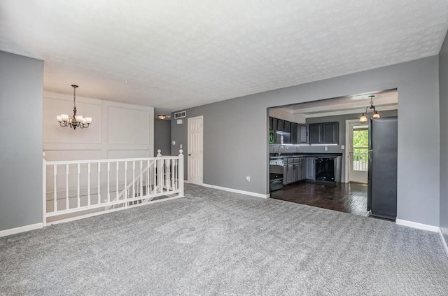 3776 Feather Ln, Elsmere, KY 41018 - empty room with dark colored carpet, a chandelier, baseboards, and a textured ceiling