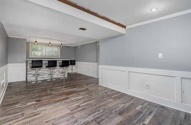 3776 Feather Ln, Elsmere, KY 41018 - unfurnished room with ornamental molding, a dry bar, wood finished floors, a wainscoted wall, and a decorative wall