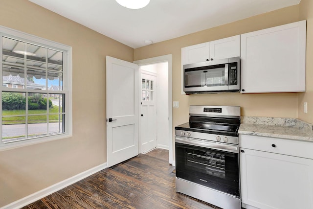 1191 Wilson Rd, Bellevue, KY 41073 - kitchen with appliances with stainless steel finishes, dark wood-type flooring, baseboards, white cabinets, and light stone countertops