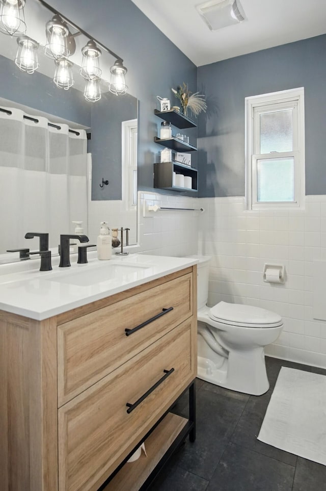 8347 Riley Rd, Alexandria, KY 41001 - bathroom featuring tile walls, tile patterned floors, vanity, toilet, and wainscoting