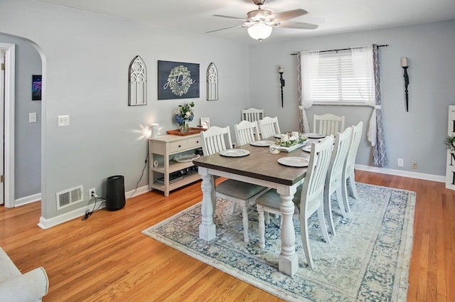 8347 Riley Rd, Alexandria, KY 41001 - dining room featuring arched walkways, a ceiling fan, light wood finished floors, and baseboards