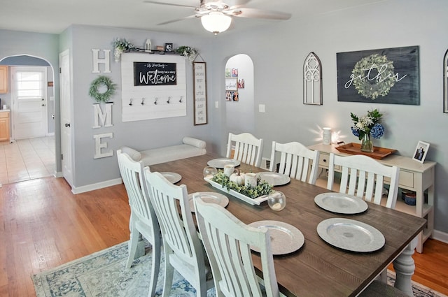 8347 Riley Rd, Alexandria, KY 41001 - dining space featuring arched walkways, a ceiling fan, baseboards, and light wood-style flooring