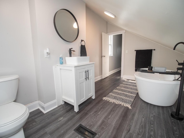 320 W 10th St, Newport, KY 41071 - bathroom featuring lofted ceiling, vanity, toilet, a soaking tub, and wood finished floors