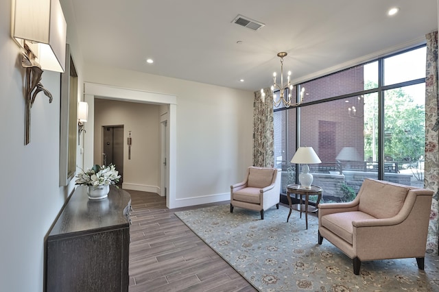 1 Highland Ave Unit 208, Fort Thomas, KY 41075 - living area with a chandelier, wood finished floors, healthy amount of natural light, baseboards, and recessed lighting