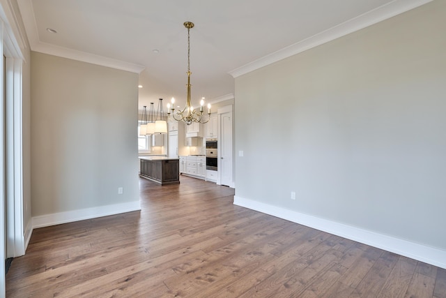 1 Highland Ave Unit 208, Fort Thomas, KY 41075 - unfurnished living room featuring a chandelier, crown molding, wood finished floors, and baseboards