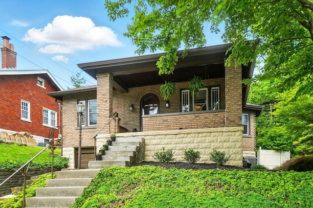 134 Strathmore Ave, Fort Thomas, KY 41075 - view of front of property featuring stairs, a porch, brick siding, and central air condition unit