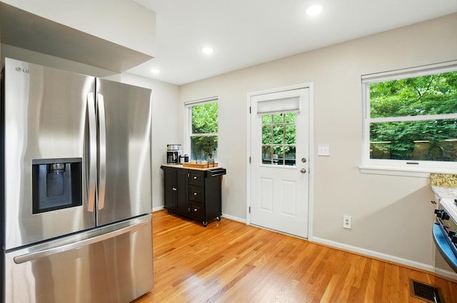 134 Strathmore Ave, Fort Thomas, KY 41075 - kitchen with stainless steel refrigerator with ice dispenser, light countertops, light wood-type flooring, dark cabinetry, and baseboards