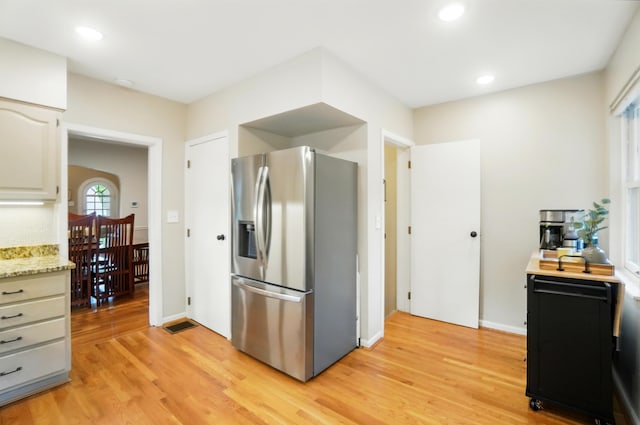 134 Strathmore Ave, Fort Thomas, KY 41075 - kitchen featuring stainless steel fridge with ice dispenser, light wood finished floors, light stone counters, and recessed lighting