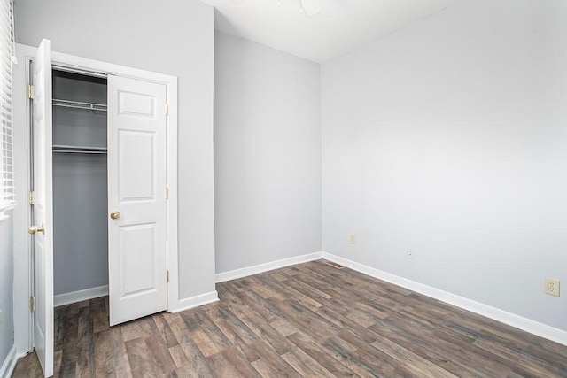 718 Central Ave, Newport, KY 41071 - unfurnished bedroom featuring wood finished floors, baseboards, and a closet