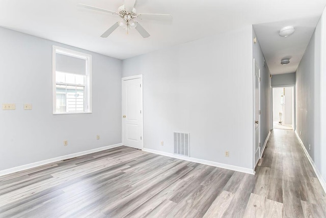 718 Central Ave, Newport, KY 41071 - spare room with wood finished floors, a ceiling fan, and baseboards