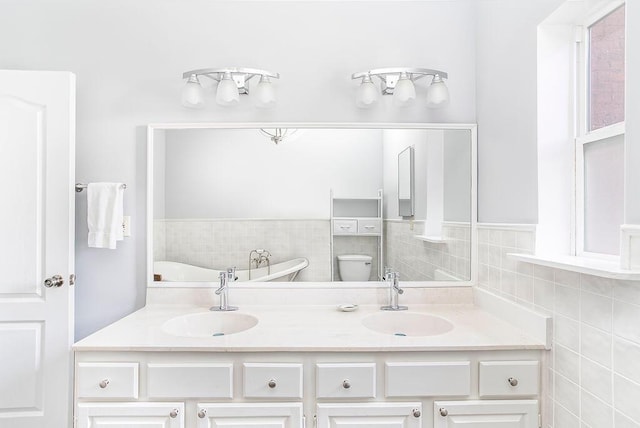 718 Central Ave, Newport, KY 41071 - bathroom featuring tile walls, double vanity, toilet, and a tub