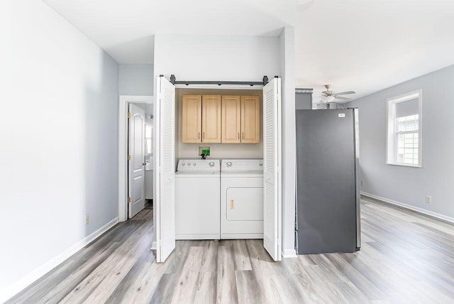 718 Central Ave, Newport, KY 41071 - laundry area featuring cabinet space, washer and clothes dryer, light wood-type flooring, a ceiling fan, and baseboards