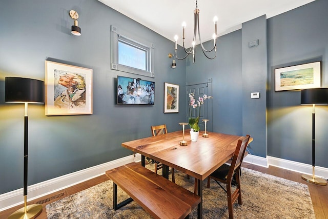 842 Monroe St, Newport, KY 41071 - dining space featuring wood finished floors, a chandelier, and a high ceiling