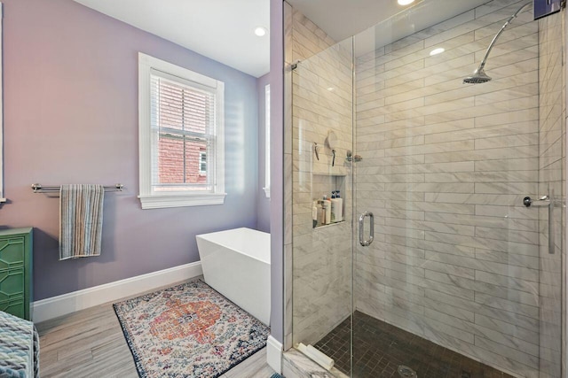 842 Monroe St, Newport, KY 41071 - full bathroom with a shower stall, a freestanding tub, wood finished floors, and recessed lighting