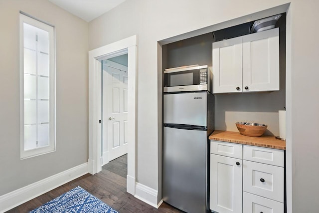 842 Monroe St, Newport, KY 41071 - kitchen with appliances with stainless steel finishes, dark wood-style flooring, and white cabinets