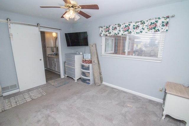 1727 Shaw Rd, Independence, KY 41051 - bedroom with a barn door, carpet flooring, connected bathroom, and ceiling fan