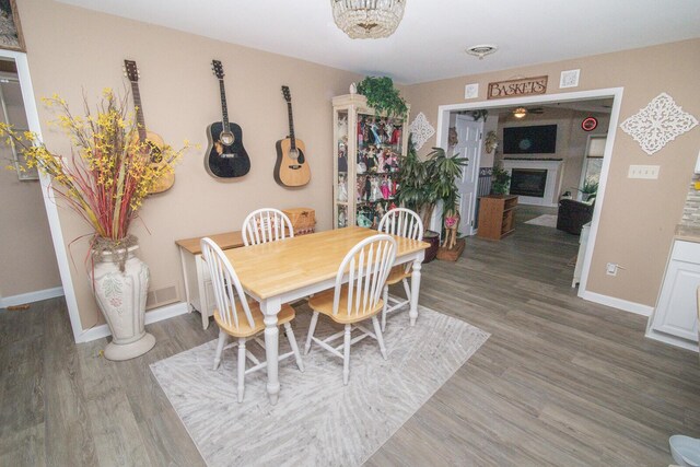 1727 Shaw Rd, Independence, KY 41051 - dining area with wood finished floors, a fireplace, and baseboards