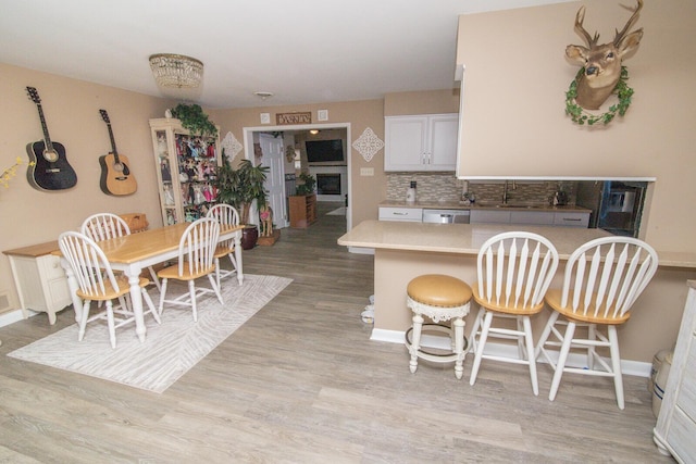 1727 Shaw Rd, Independence, KY 41051 - kitchen with light wood finished floors, dishwasher, tasteful backsplash, light countertops, and a sink