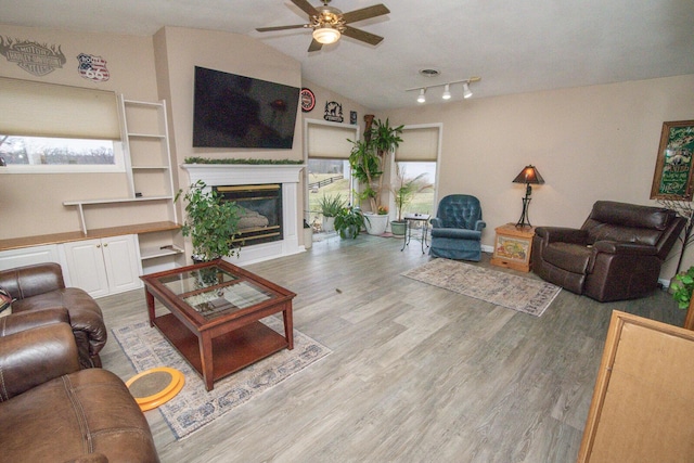 1727 Shaw Rd, Independence, KY 41051 - living area with ceiling fan, healthy amount of natural light, a glass covered fireplace, wood finished floors, and lofted ceiling