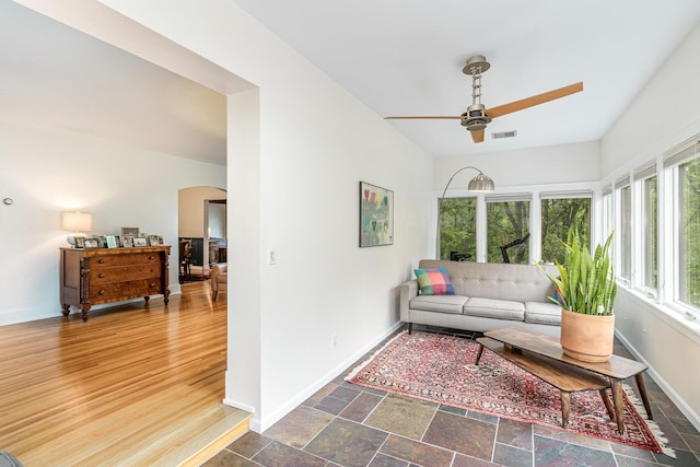 1058 Emerson Rd, Park Hills, KY 41011 - living room featuring ceiling fan, baseboards, and arched walkways