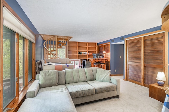 1058 Emerson Rd, Park Hills, KY 41011 - carpeted living area featuring a textured ceiling and stairway