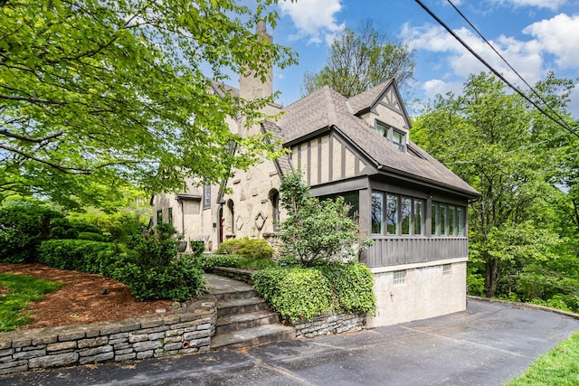 1058 Emerson Rd, Park Hills, KY 41011 - english style home with a chimney, a sunroom, and a shingled roof